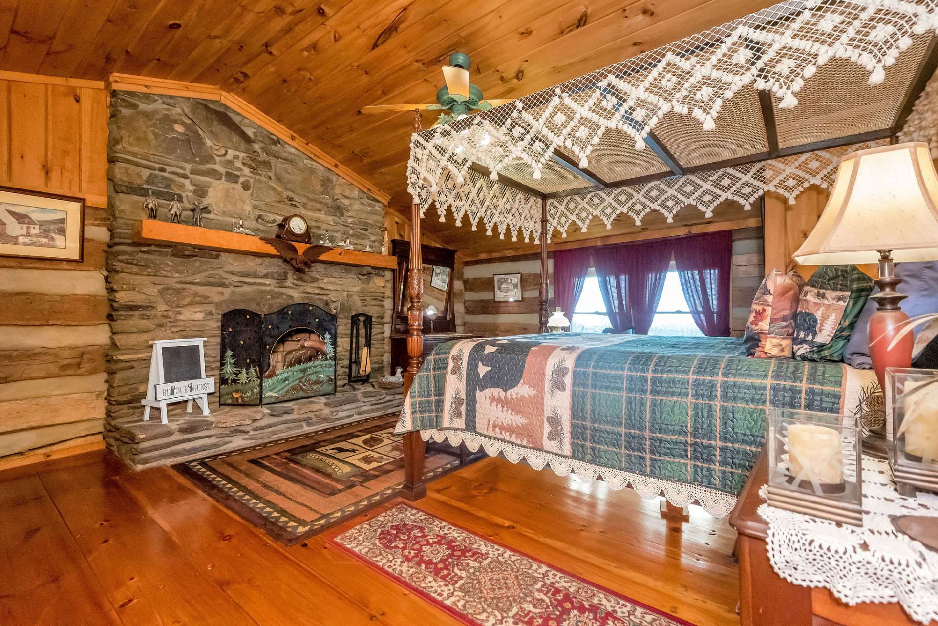 The first upper-level guest bedroom offers a wood-burning fireplace, vaulted ceilings, and view.