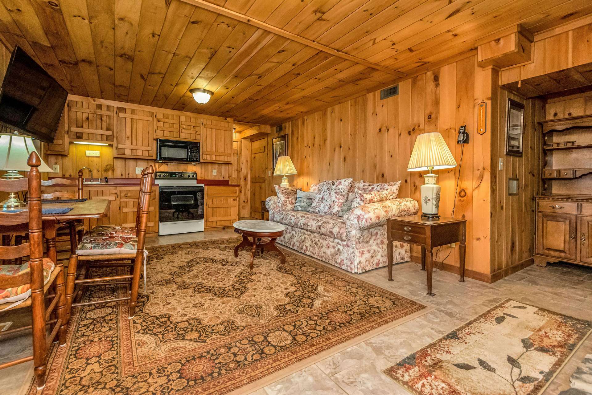 The kitchenette is complete with sink, electric range, & microwave. There's a mini fridge conveying or add a full size refrigerator beside the stove.