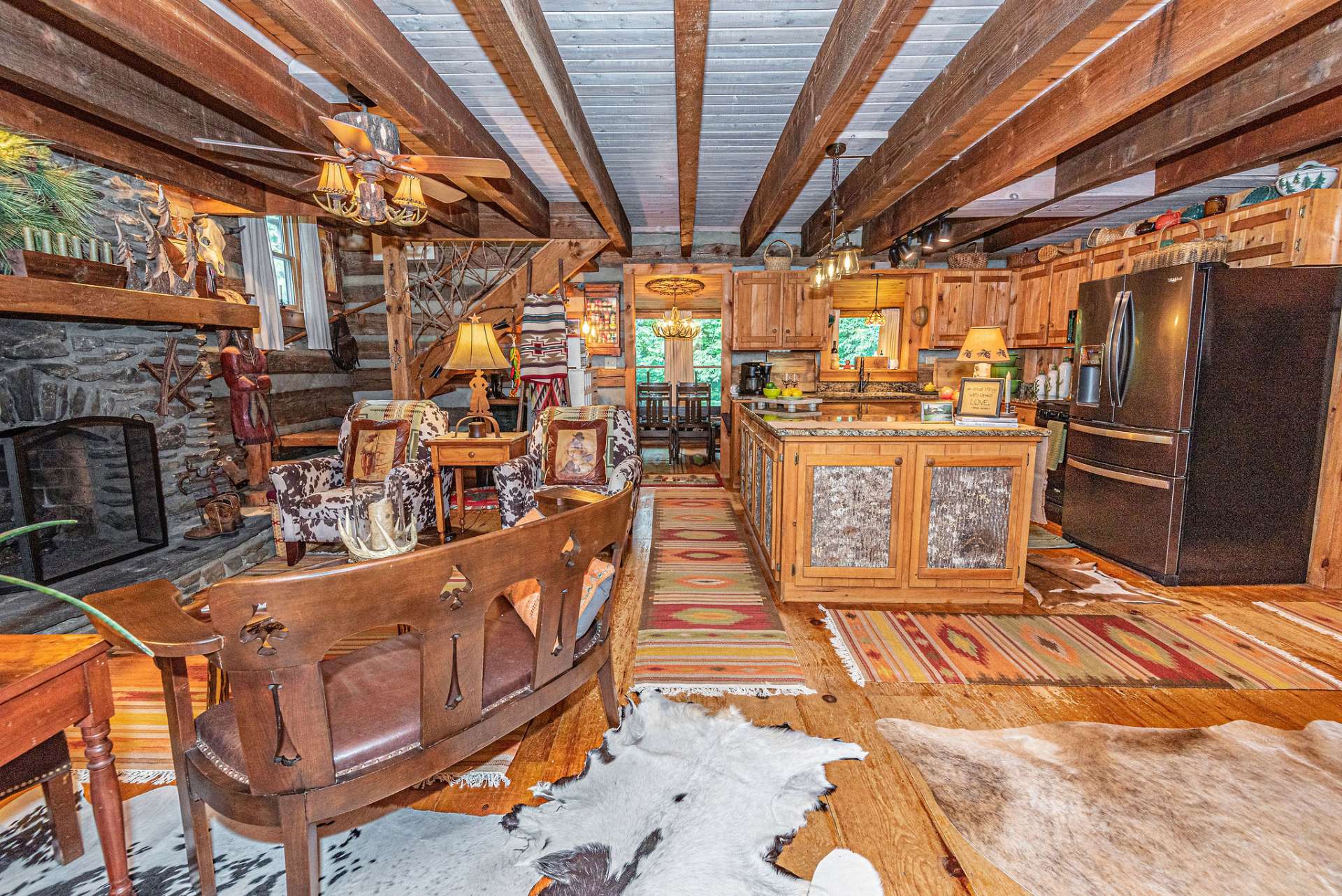 One step inside and you'll appreciate the cabin's rustic elegance with wood beamed ceilings, wide plank flooring and the island's custom cabinetry with bark siding details.