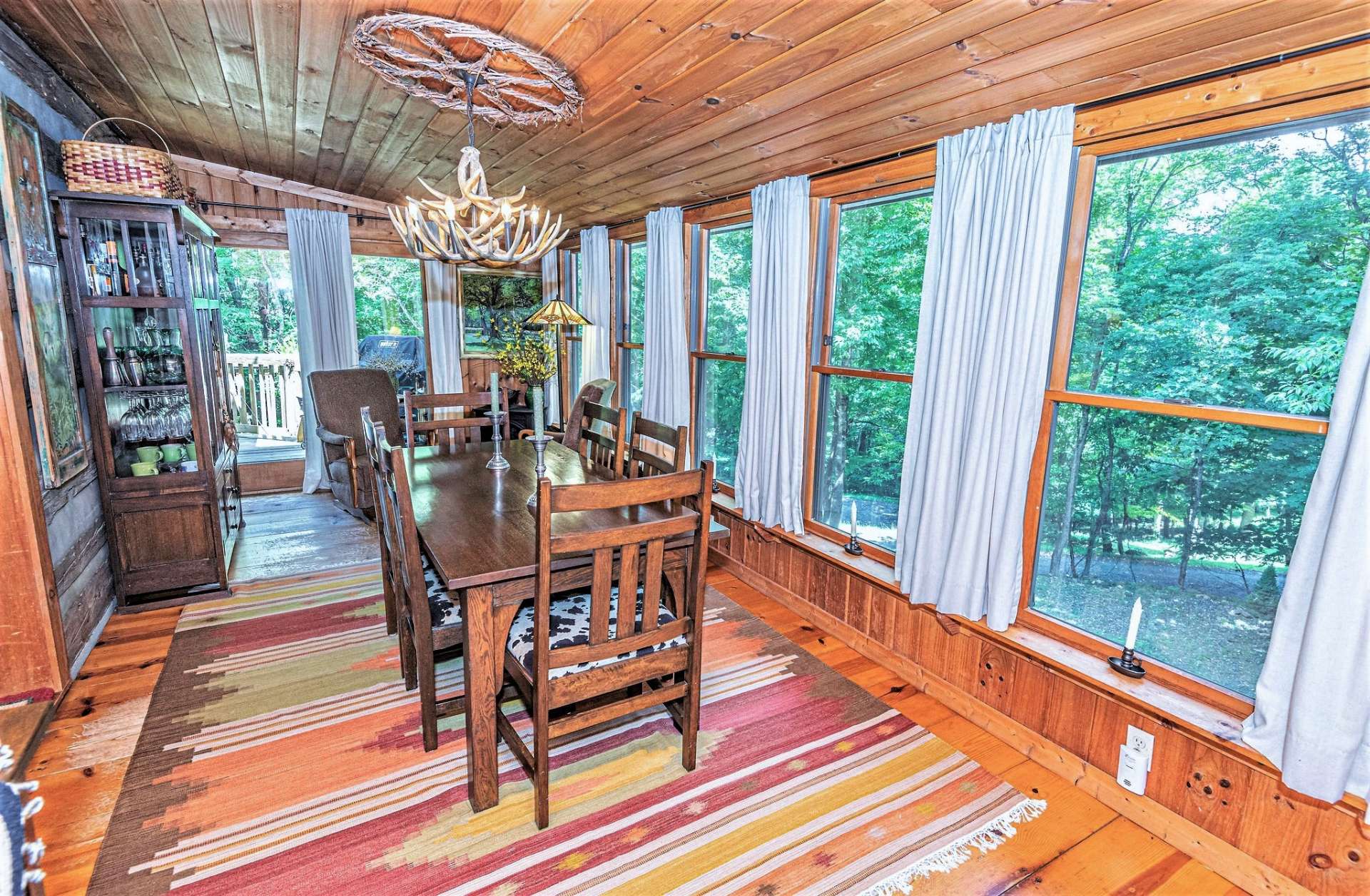 This room is completely surrounded by windows to bring in the feeling of a screened porch in the summer yet completely useable during winter with convenient access to side deck for easy entertaining.