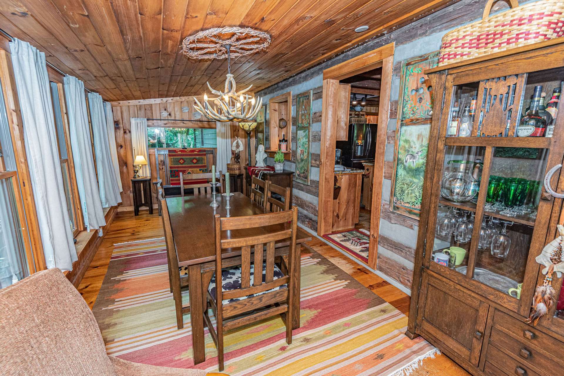 Just off the kitchen is a large dining room and seating area with a cozy gas stove to warm up to during the winter months.