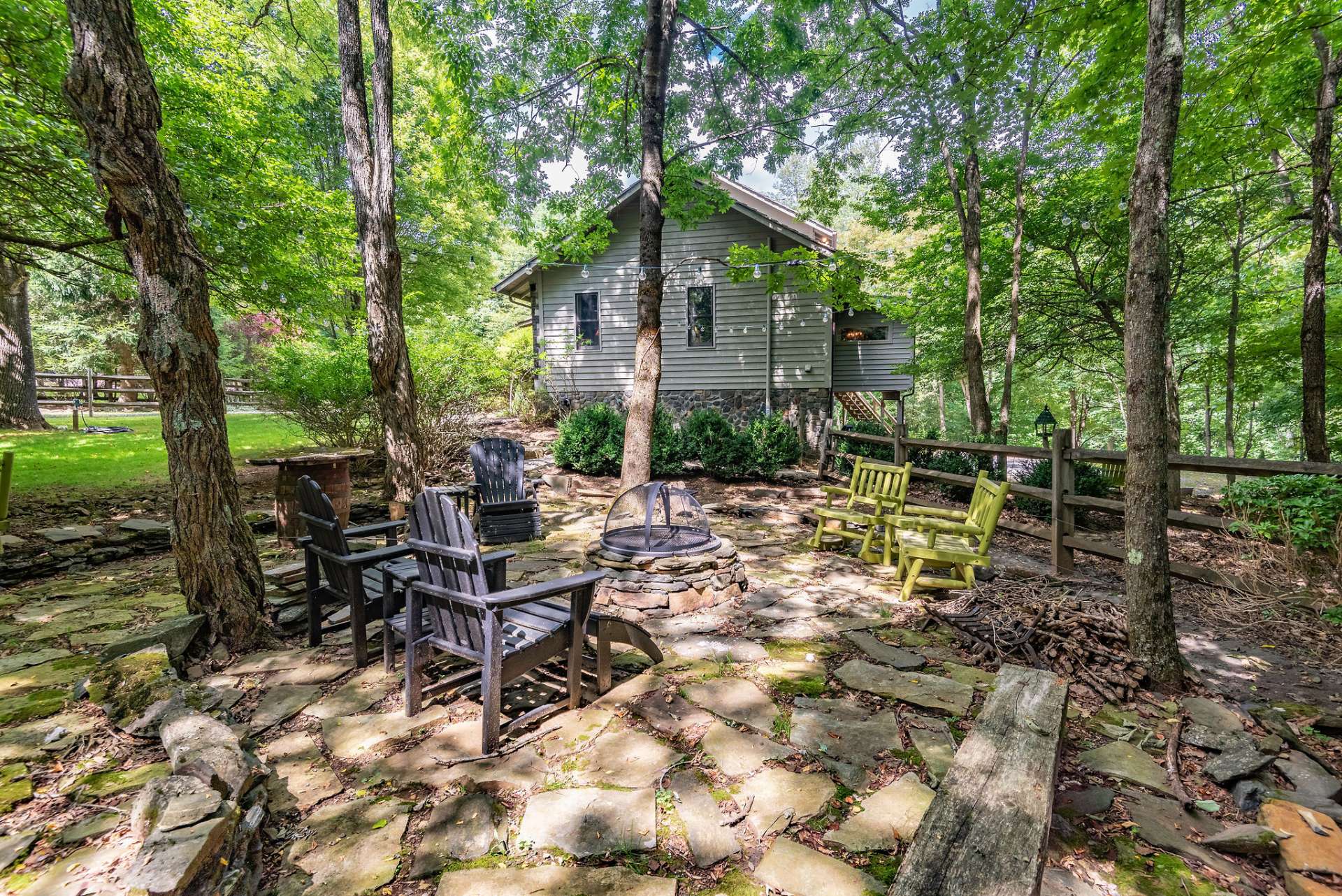 Side yard has a flagstone patio with firepit area for toasting marshmallows and enjoying cool nights.