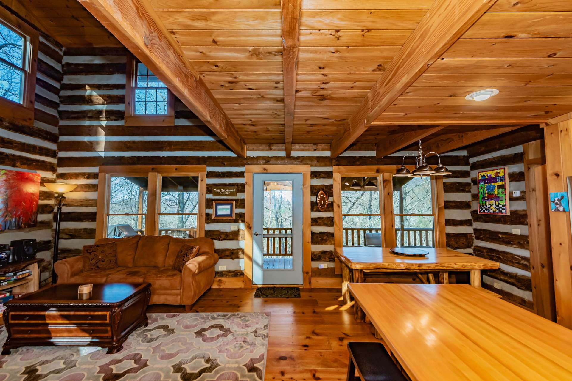 Entering from the front door, the open floor plan draws you in with a peek to the back deck.