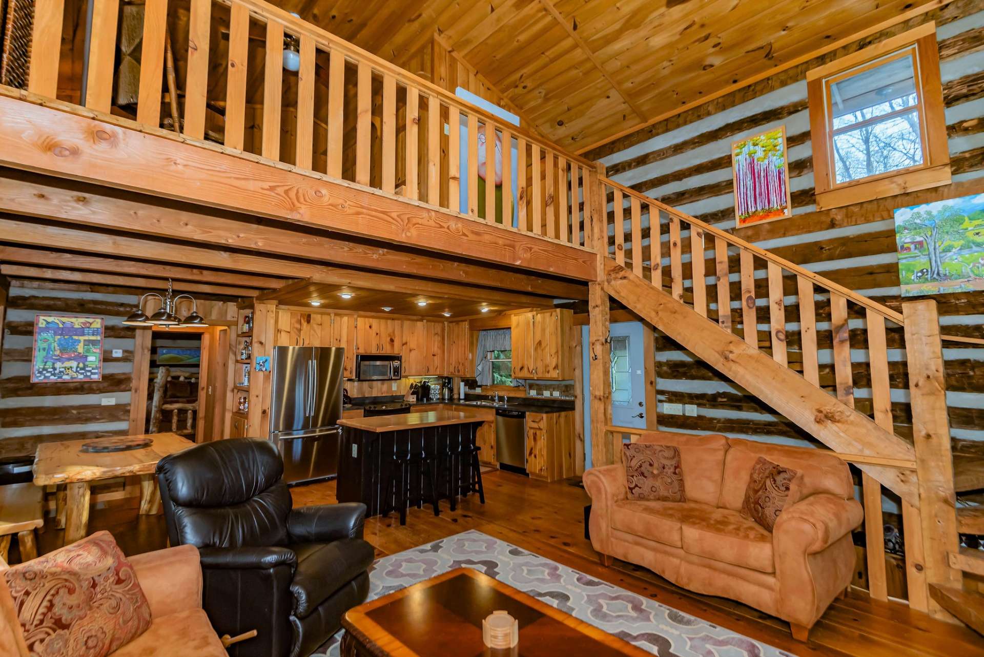 An open stairway with hand-hewn steps lead to the spacious loft.
