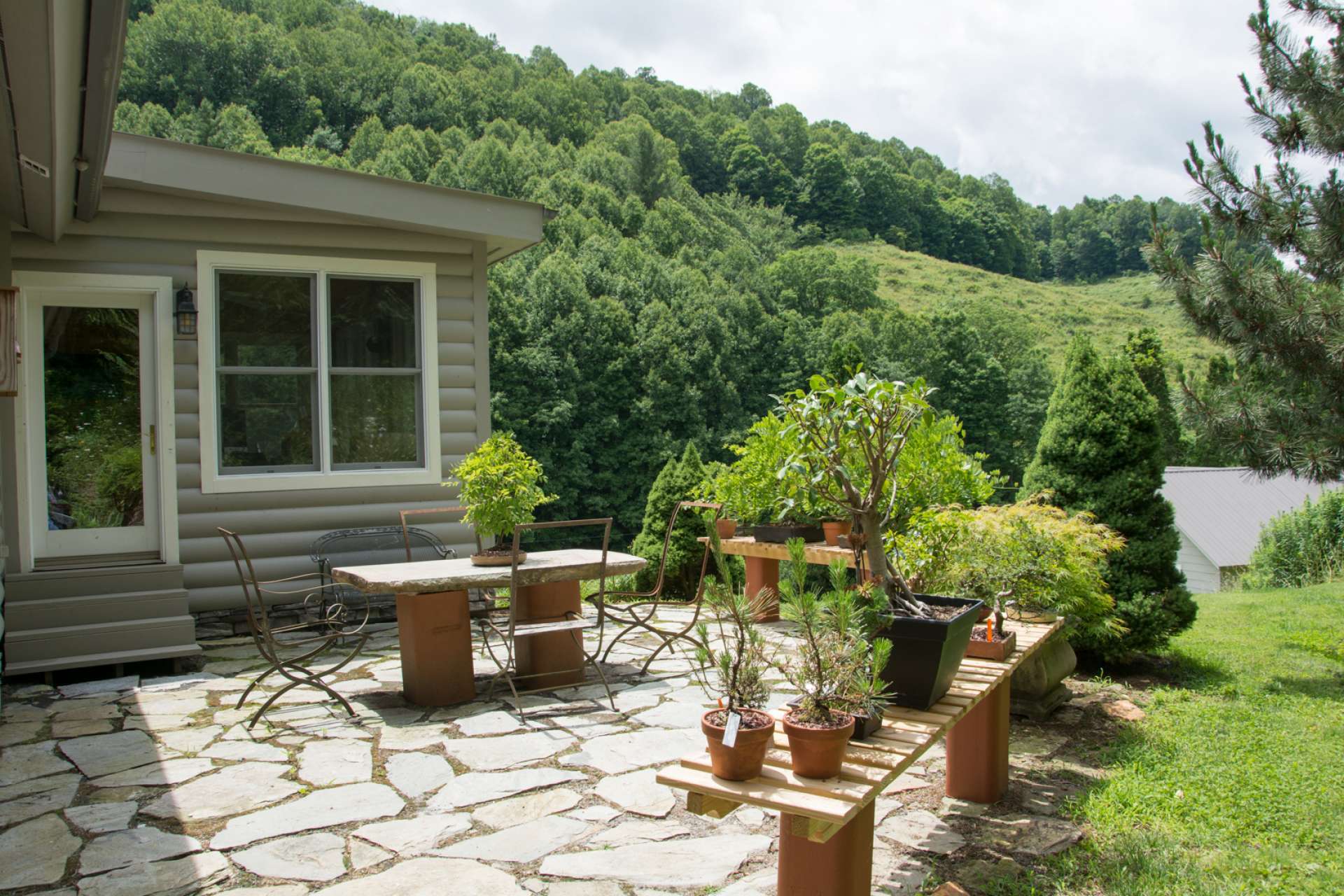 For added outdoor living and entertaining space, this patio is adorned with plants and flowers.