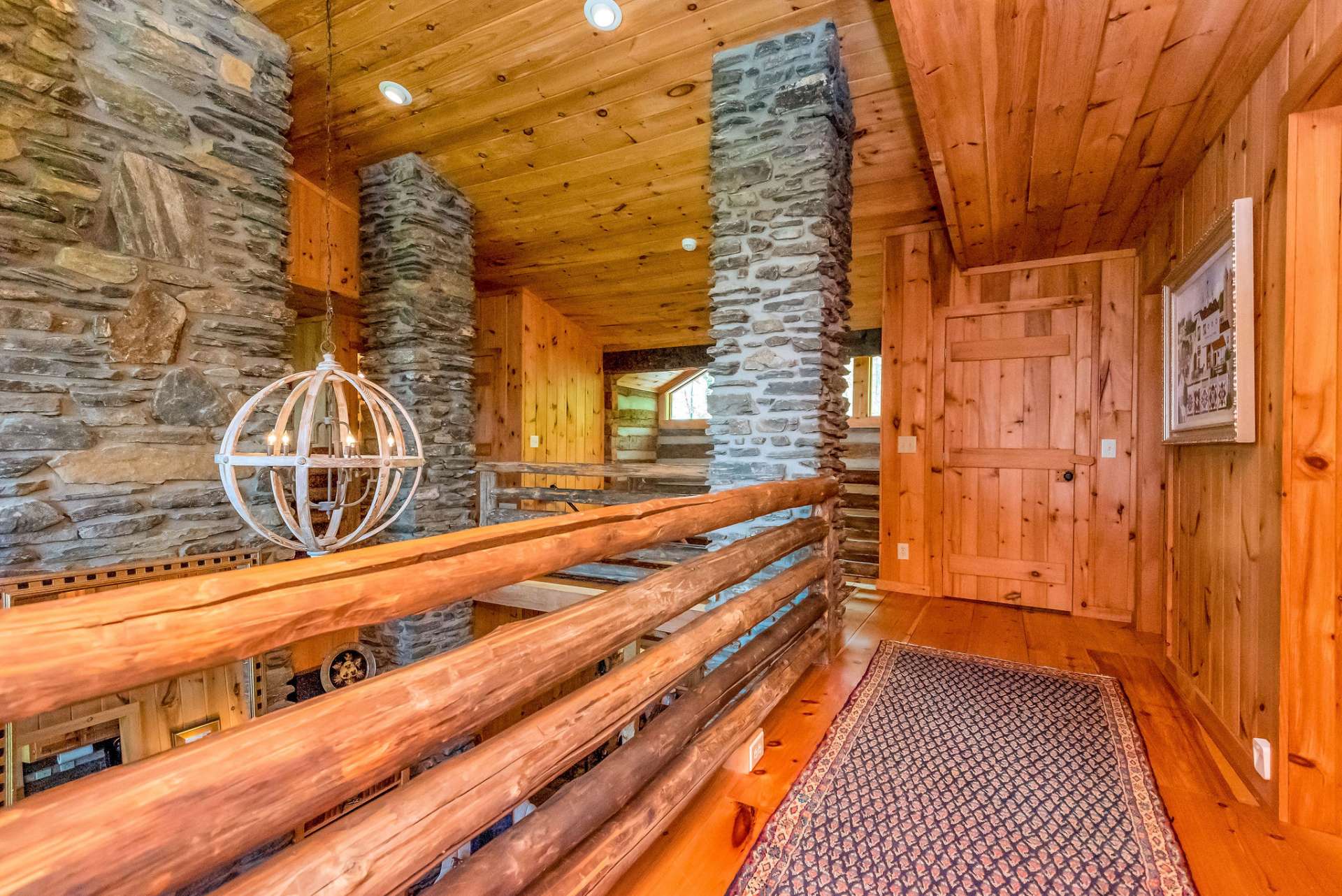 Open walkway provides access to sitting area, guest bedroom, two bonus rooms providing additional sleeping space and two baths on the upper level. PLEASE NOTE this cabin has a 2-bedroom septic system.