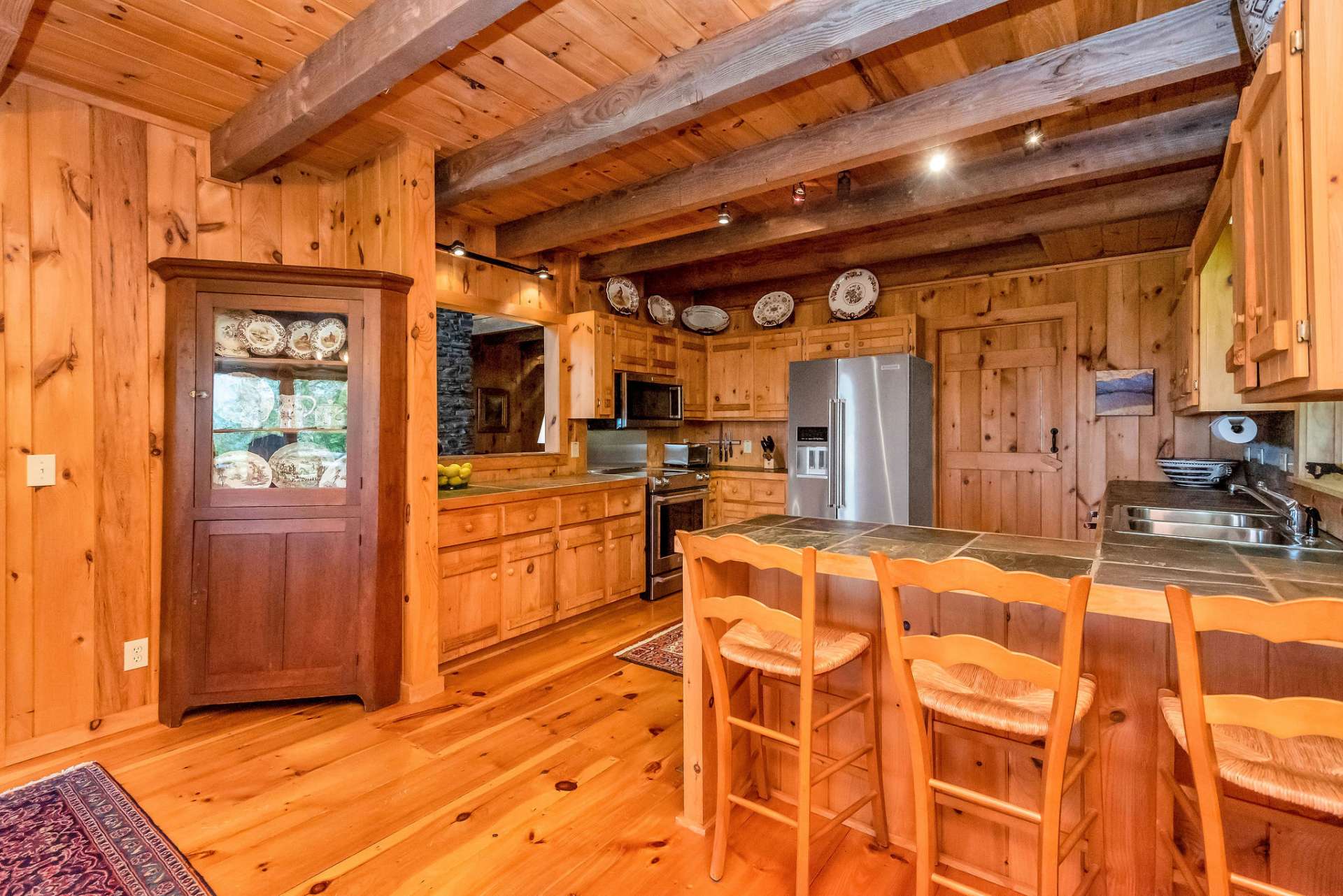 Enjoy the warmth of wood from the wide plank flooring to the exposed beams to the custom cabinetry.