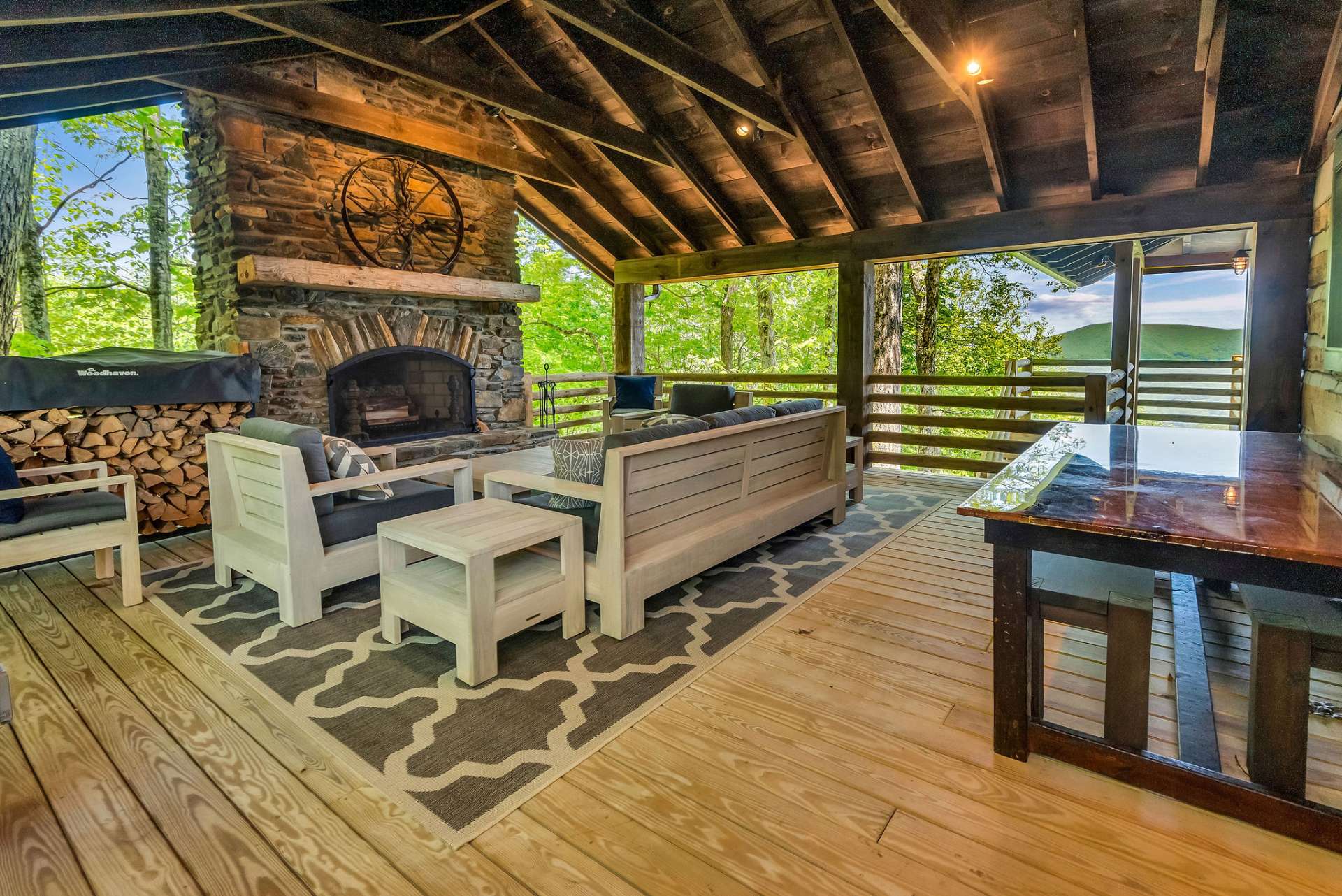 Surrounded by majestic hardwoods providing privacy, this covered porch offers plenty of space and seating for a crowd but it's also cozy enough for two.