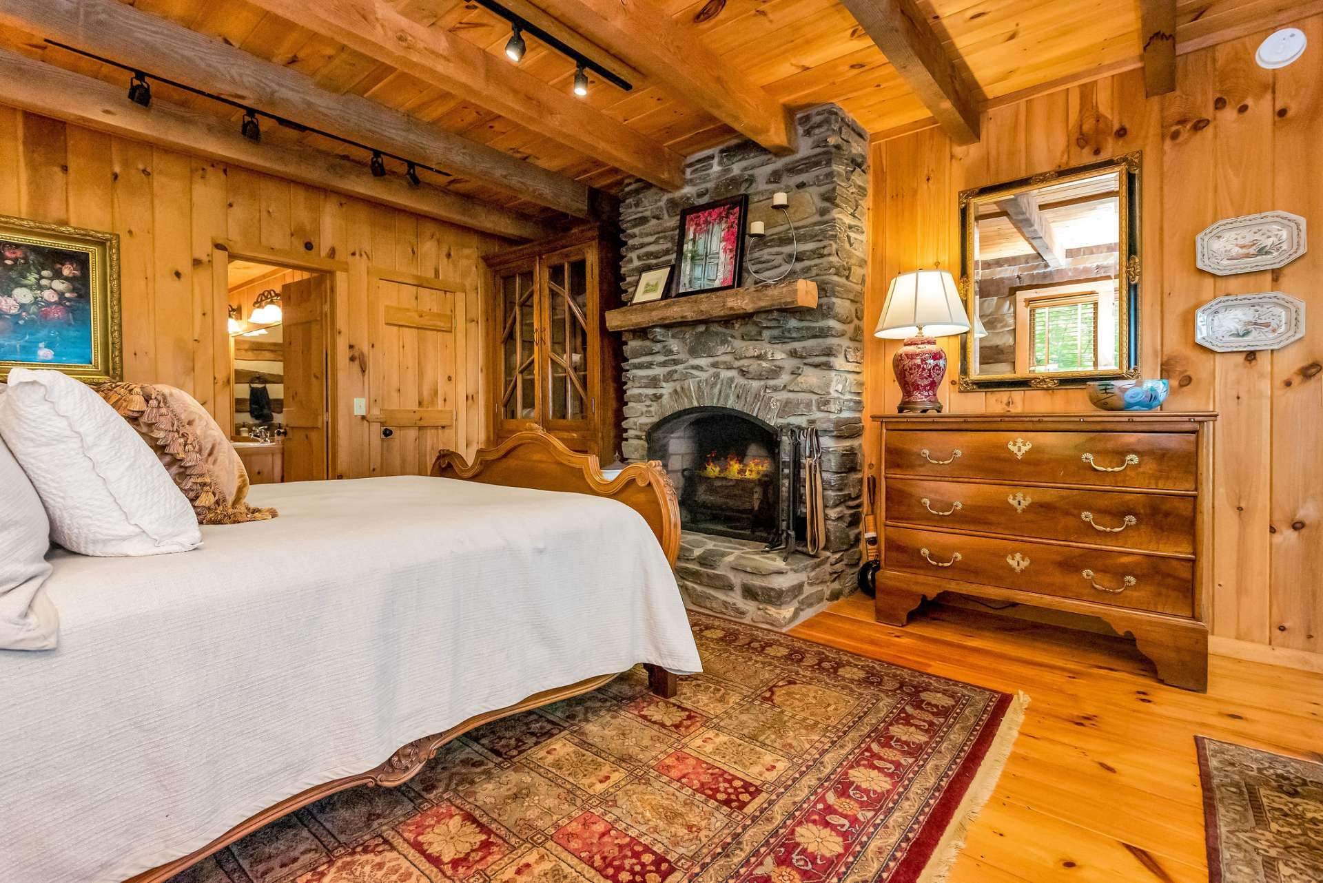 Master suite boasts its own wood-burning fireplace and his/her closets.
