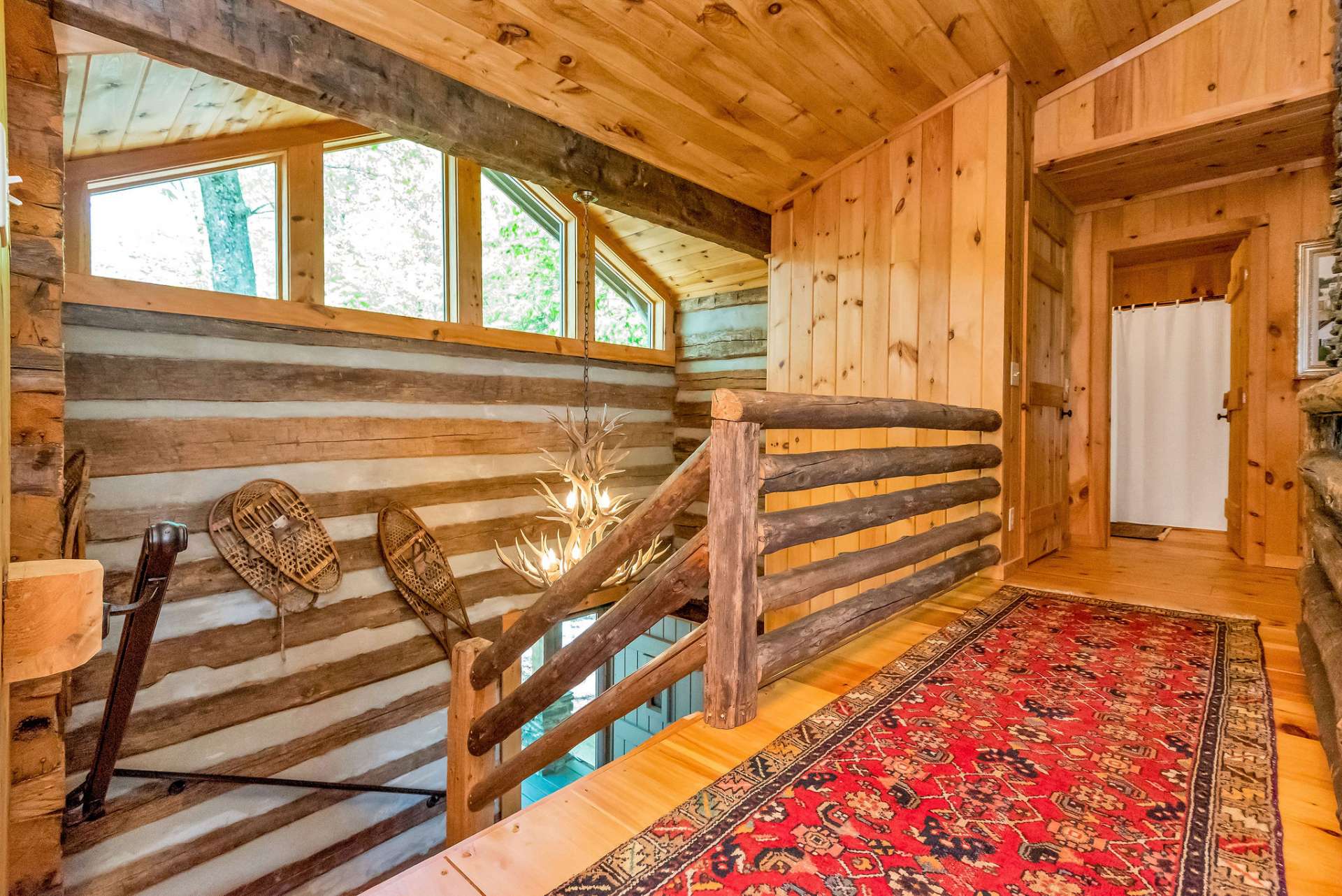 Unique architectural design is accentuated on the upper level with open walkways looking down on the foyer below, as well as the living area on the other side.