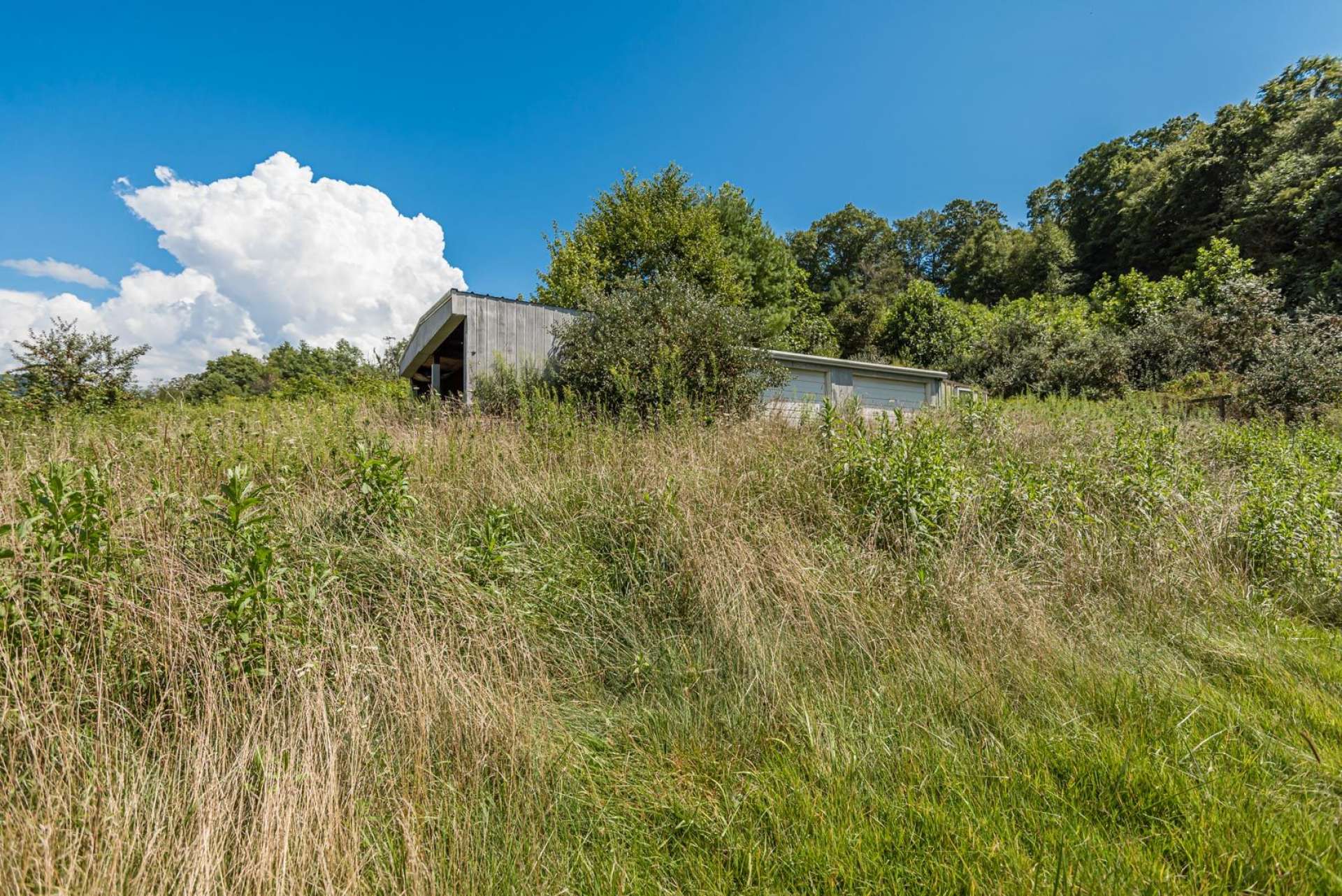 This 2-bay garage with side shed added  will work nicely for equipment storage as well as livestock shelter.