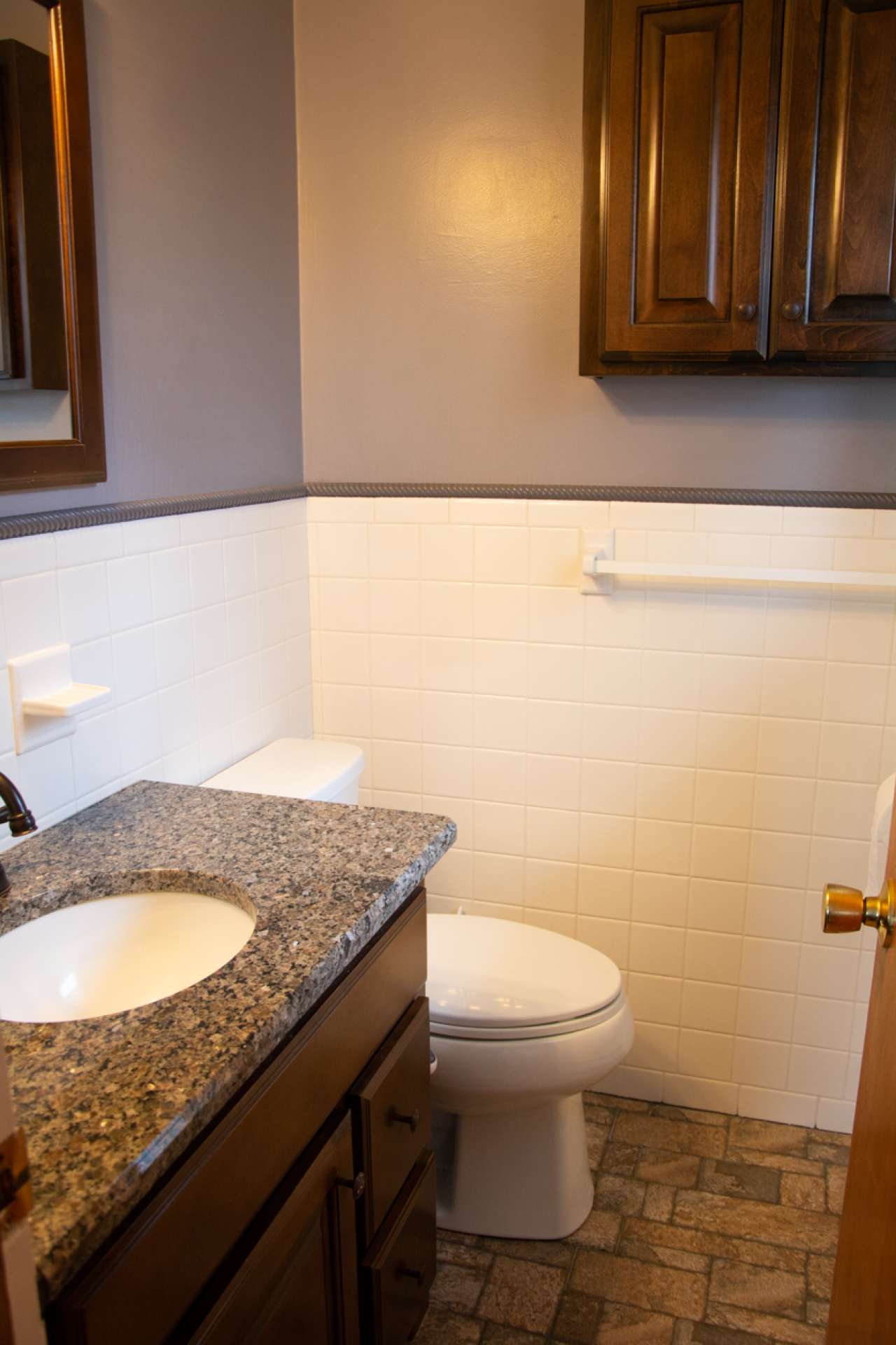 Master includes half bath with ceramic tile floor and granite counter top with single vanity.