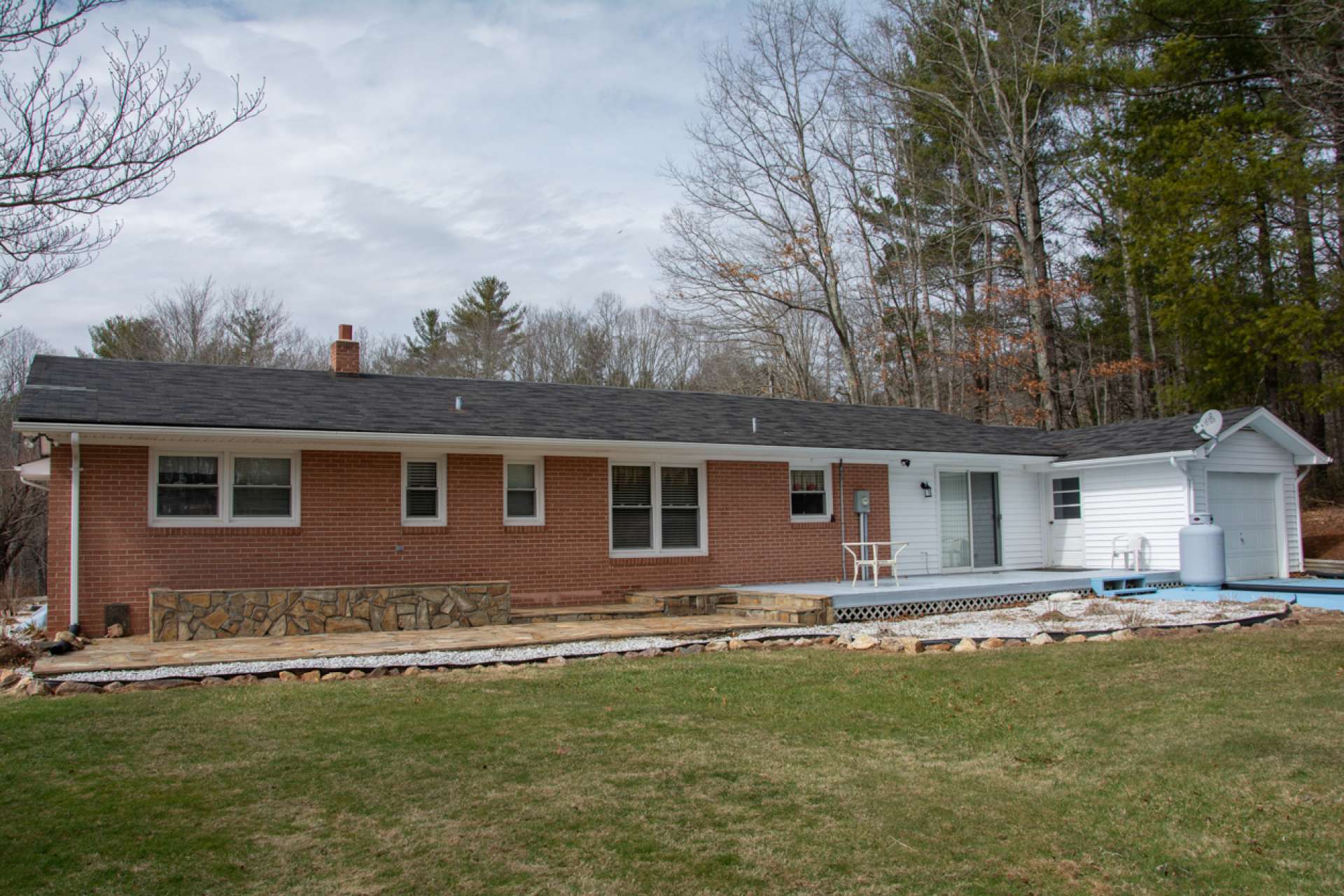 Behind the house, enjoy an open deck and stone patio.