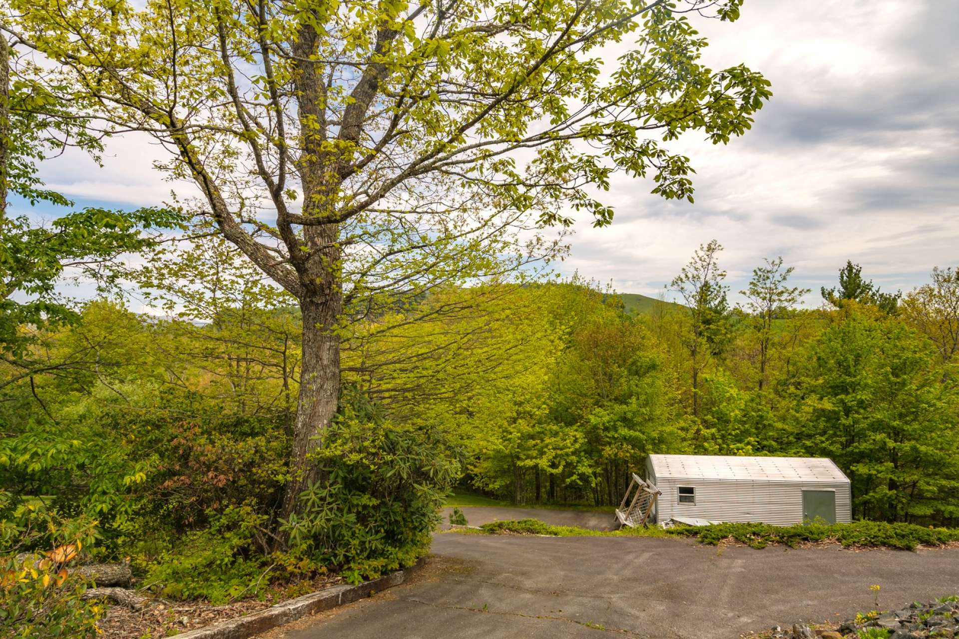 A paved driveway allows for easy year round access.  There is an outbuilding for addition storage space.