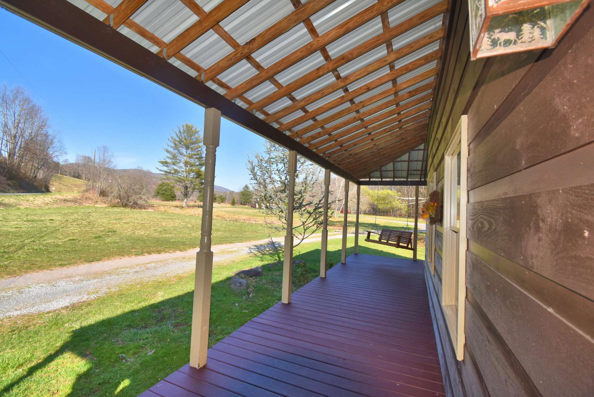 You will enjoy relaxing in the swing on the covered wrap porch. Plenty of outdoor grilling, dining, and entertaining space here.