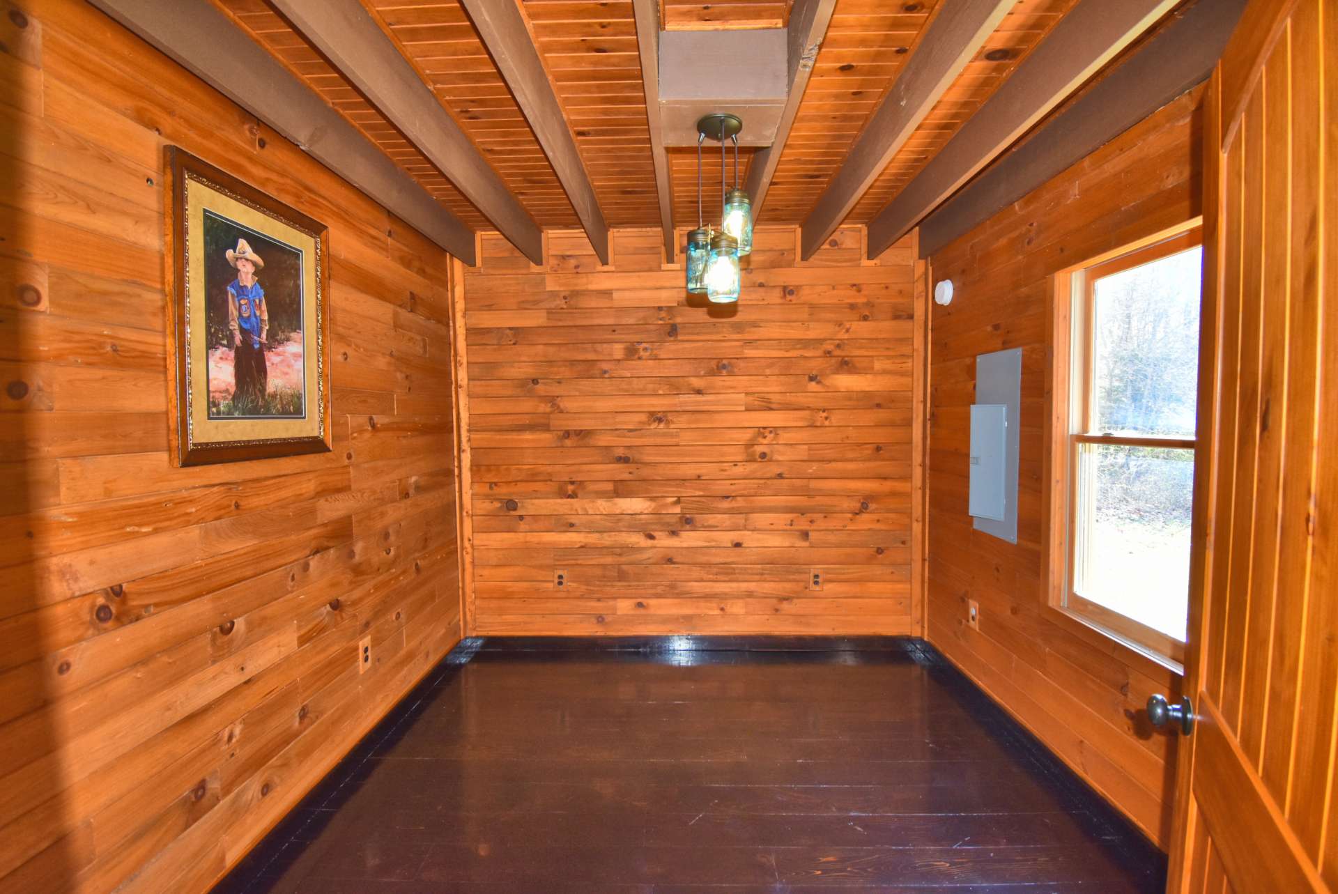 This is the second bedroom on the main level. This cabin was built as a vacation rental investment, so the bedrooms do not have closets.