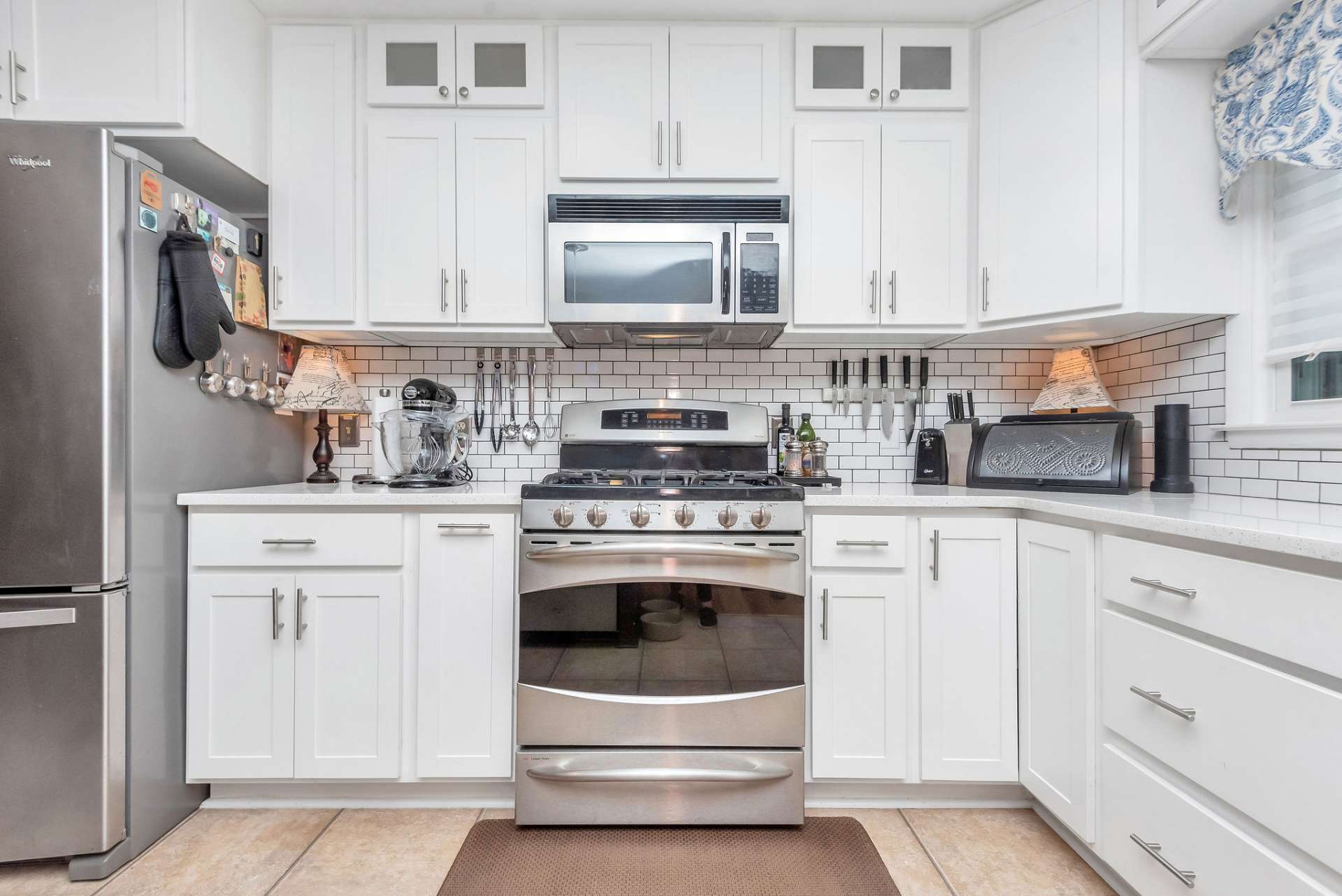 The beautiful upgraded custom kitchen features stainless appliances including this combination gas and electric stove