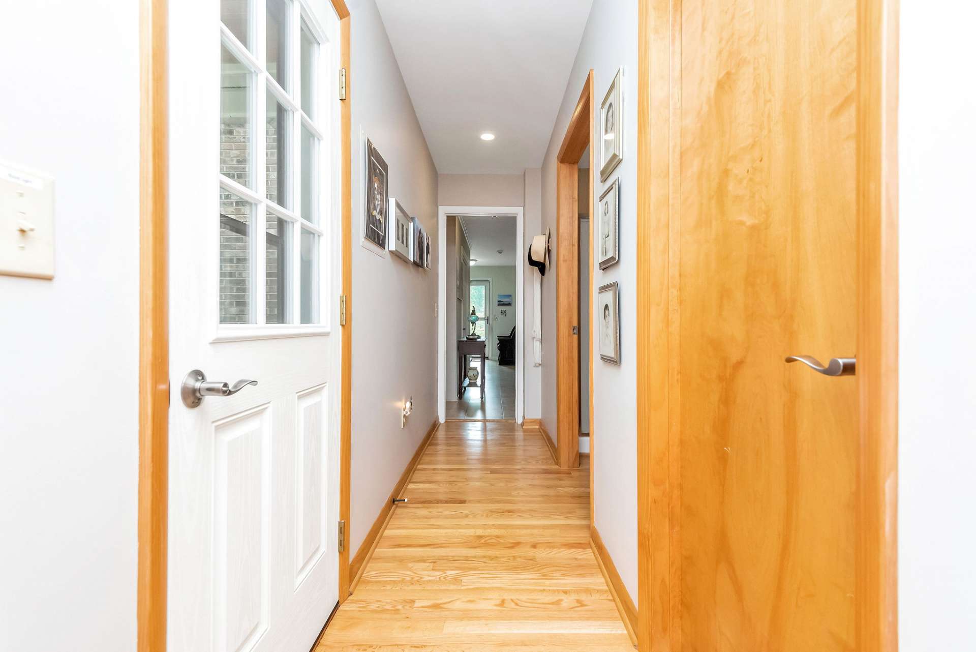 Back inside, this hallway leads from the living area to the second large storage closet, and a full bath.