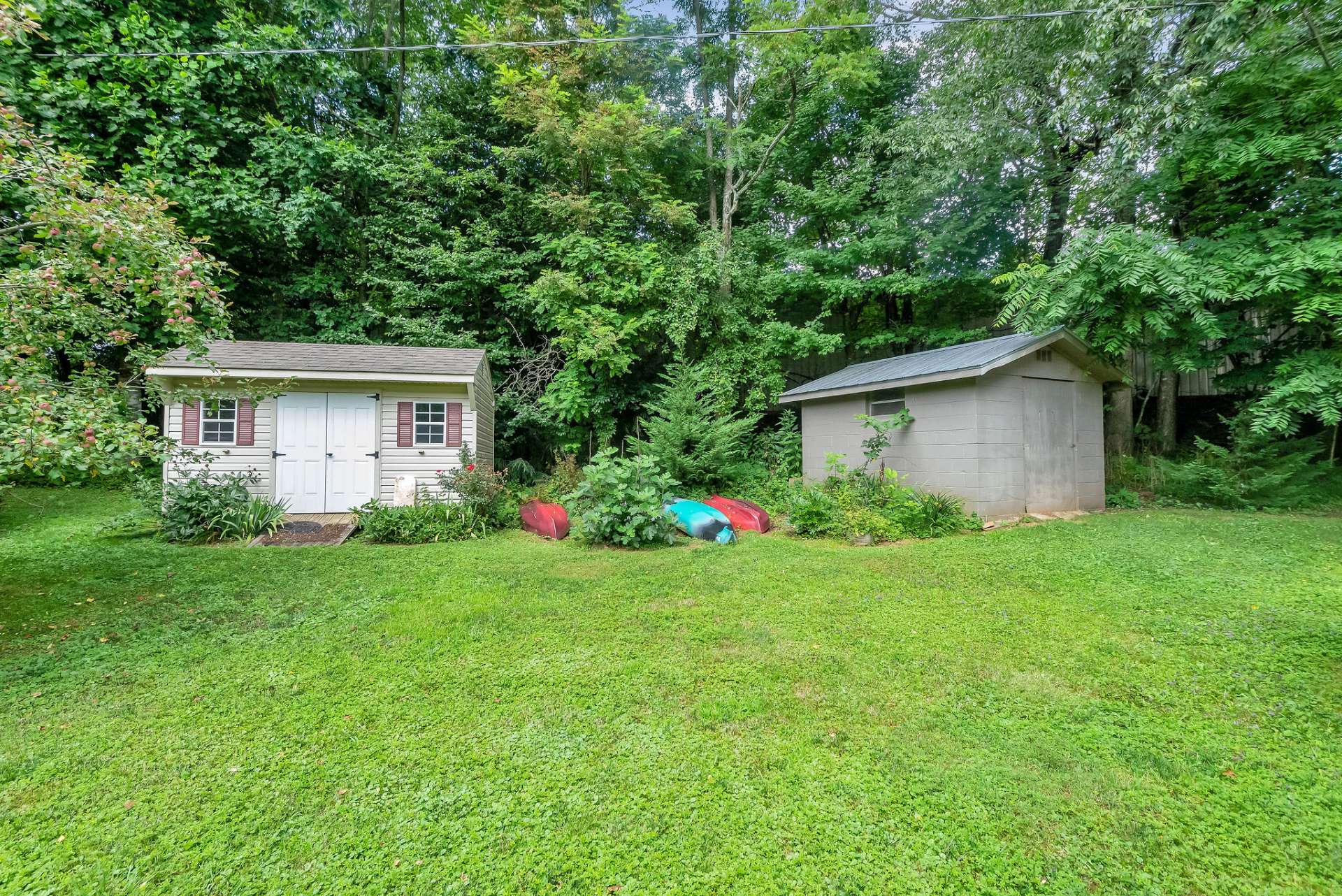 Outbuildings for storing your lawn and garden equipment, and mountain toys.