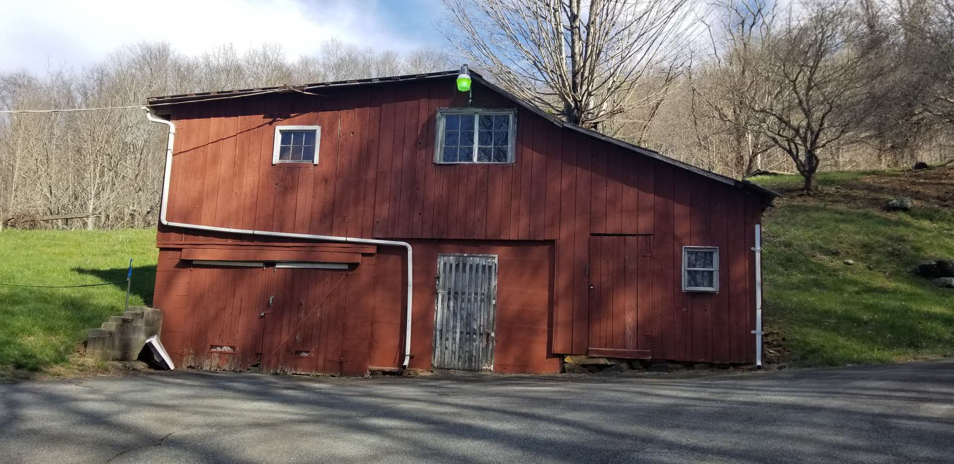 Barn with storage, work shop, and detached garage, has wood stove with flue.