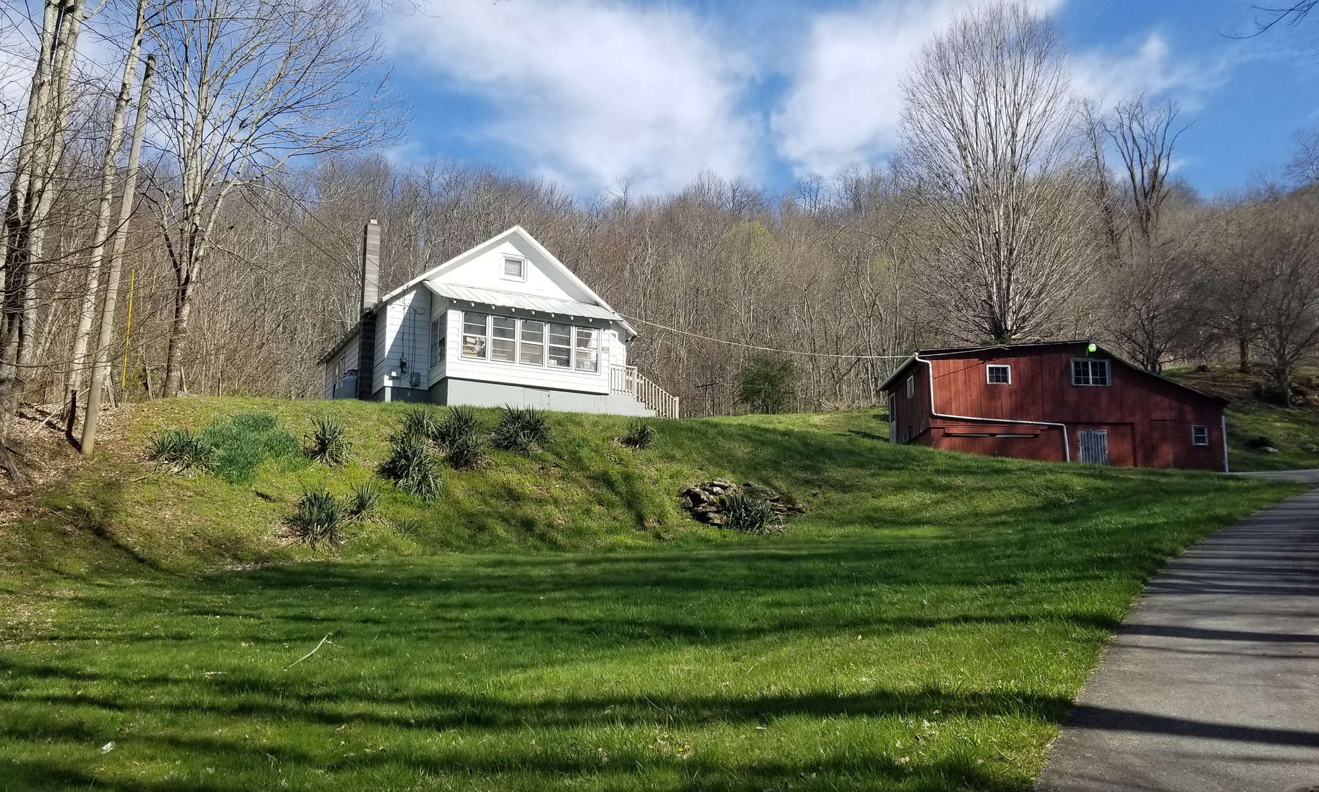 Watauga County NC Mountain Farm!  Return to old values and real farm living with this older 2-bedroom, 1-bath farmhouse nestled among 32.05 acres of both pasture and woodlands.