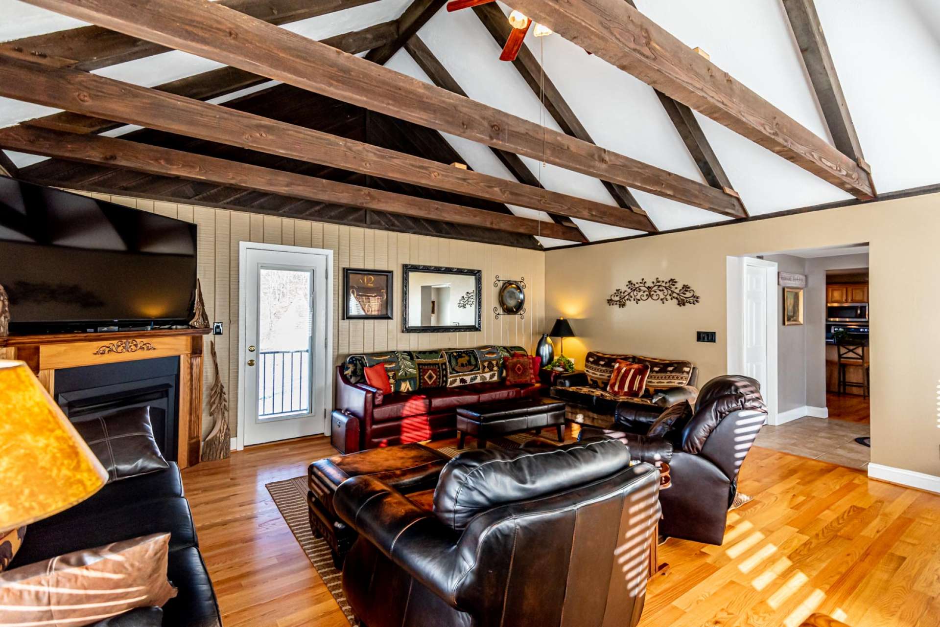 Lots of windows fill the room with natural light while the vaulted ceiling and beams add to the open feel.