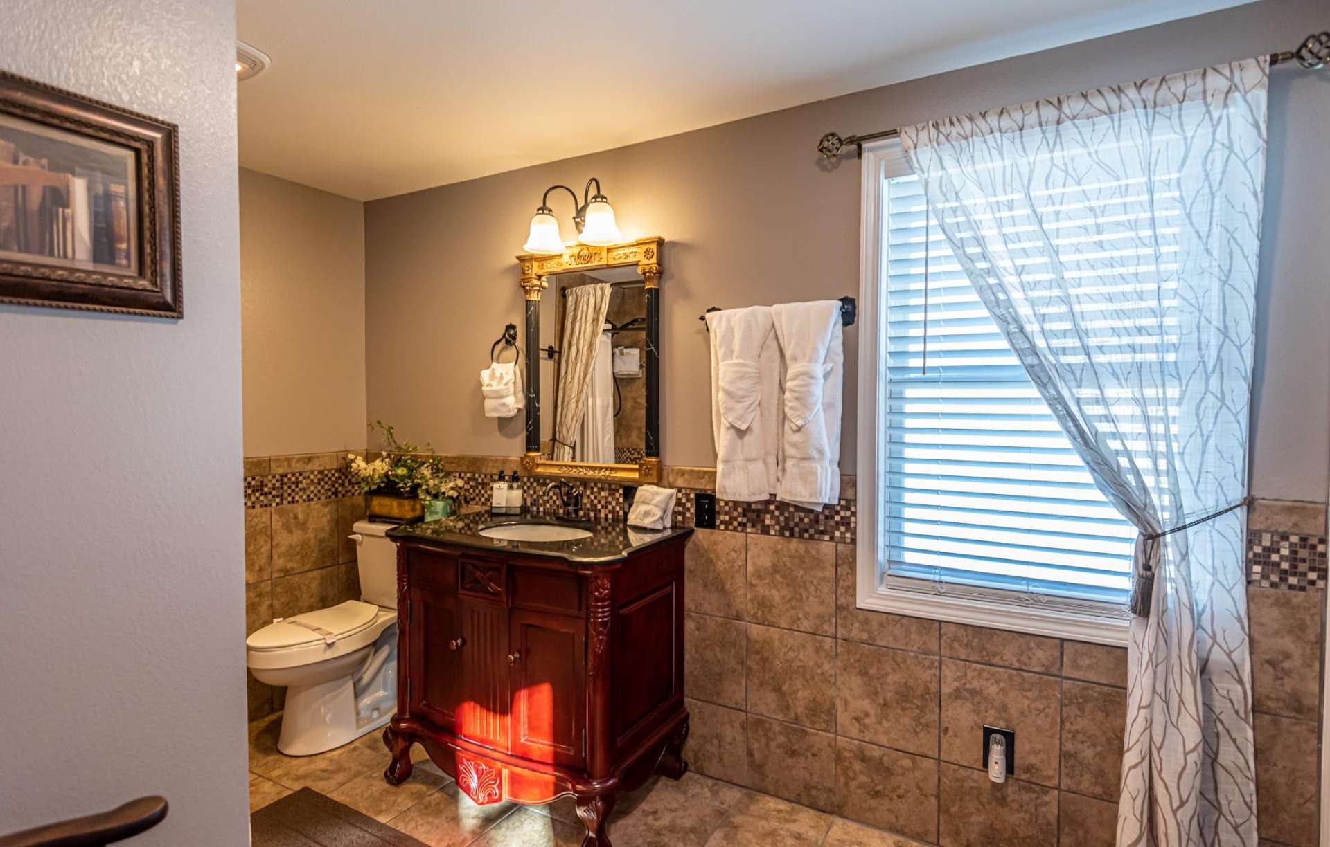 The master bath features ceramic tile floor, custom vanity, and a tiled walk-in shower.
